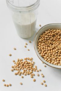Photo of Soybeans Near Drinking Glass With Soy Milk